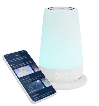 The Rest+ 2nd Gen Night Light, Sound Machine by Hatch, features a smart lamp with a digital clock display at 9:45 and is shown beside a smartphone. This setup provides portable dream machine experiences for all ages with soothing sleep sounds and reading options via an app interface.