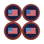 The Smathers & Branson American Flag Coasters set features four round, hand-stitched needlepoint coasters showcasing embroidered American flags—two with historic flag designs and two with the modern stars and stripes—all set in wooden frames. The set also includes a wooden coaster holder for stylish storage.