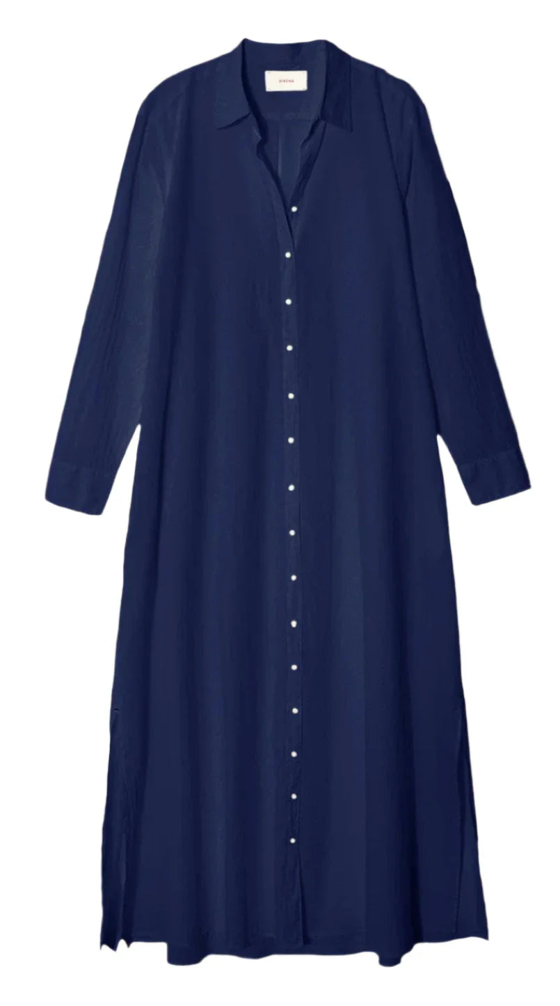 The Xirena Boden Dress by Xirena is a navy blue, long-sleeved tailored shirtdress featuring a button-down front, collar, and side seam pockets. It is crafted from lightweight woven cotton for ultimate comfort.