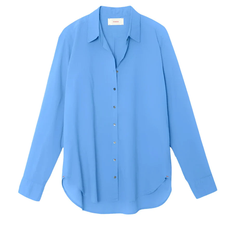 The Xirena Beau Shirt by Xirena is a blue long-sleeve button-down cotton poplin shirt with a collar, showcasing Xirena’s signature boyfriend shirt style.