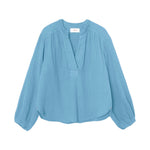 The Arielle Top by Xirena is a long-sleeved, light blue cotton gauze shirt with blouson sleeves and a short front placket, shown laid flat on a white background.