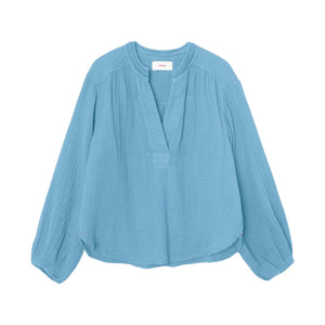 The Arielle Top by Xirena is a long-sleeved, light blue cotton gauze shirt with blouson sleeves and a short front placket, shown laid flat on a white background.