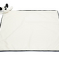 The Jellycat Bashful Black & Cream Puppy Blankie is a square white blanket with a black border, featuring a plush dog head with soft fur attached to one corner - an adorable addition from Jellycat.