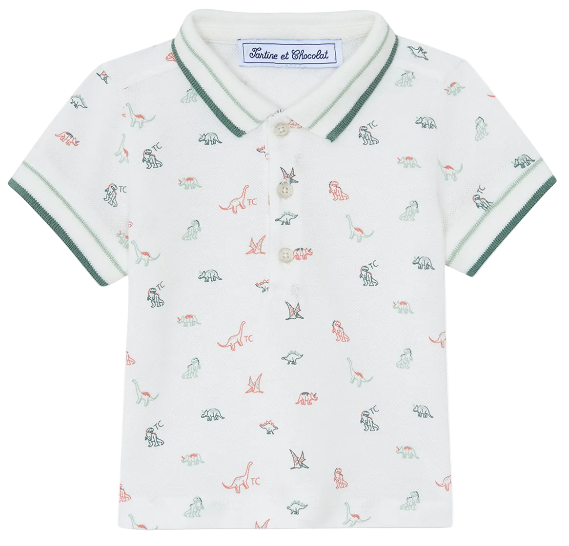 The Tartine et Chocolat Baby Boys’ and Boys’ Knitted Polo Shirt is a white short-sleeve polo crafted from soft cotton, featuring green trim, a small multicolored dinosaur pattern, a buttoned collar, and an inner label with the brand name.