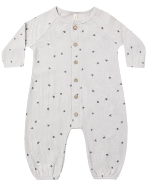 The Quincy Mae Baby Boys’ Waffle Long Sleeve Jumpsuit, shown flat on a white background, features a cozy waffle knit fabric with a subtle small star pattern, front button closure, and elasticized cuffs.