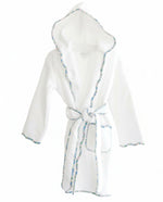 The Terry Tots Kids’ Bathrobe in white is crafted from plush terrycloth and features a blue scalloped floral trim along the edges. This hooded, belted bathrobe includes two front pockets and is shown against a plain white background.