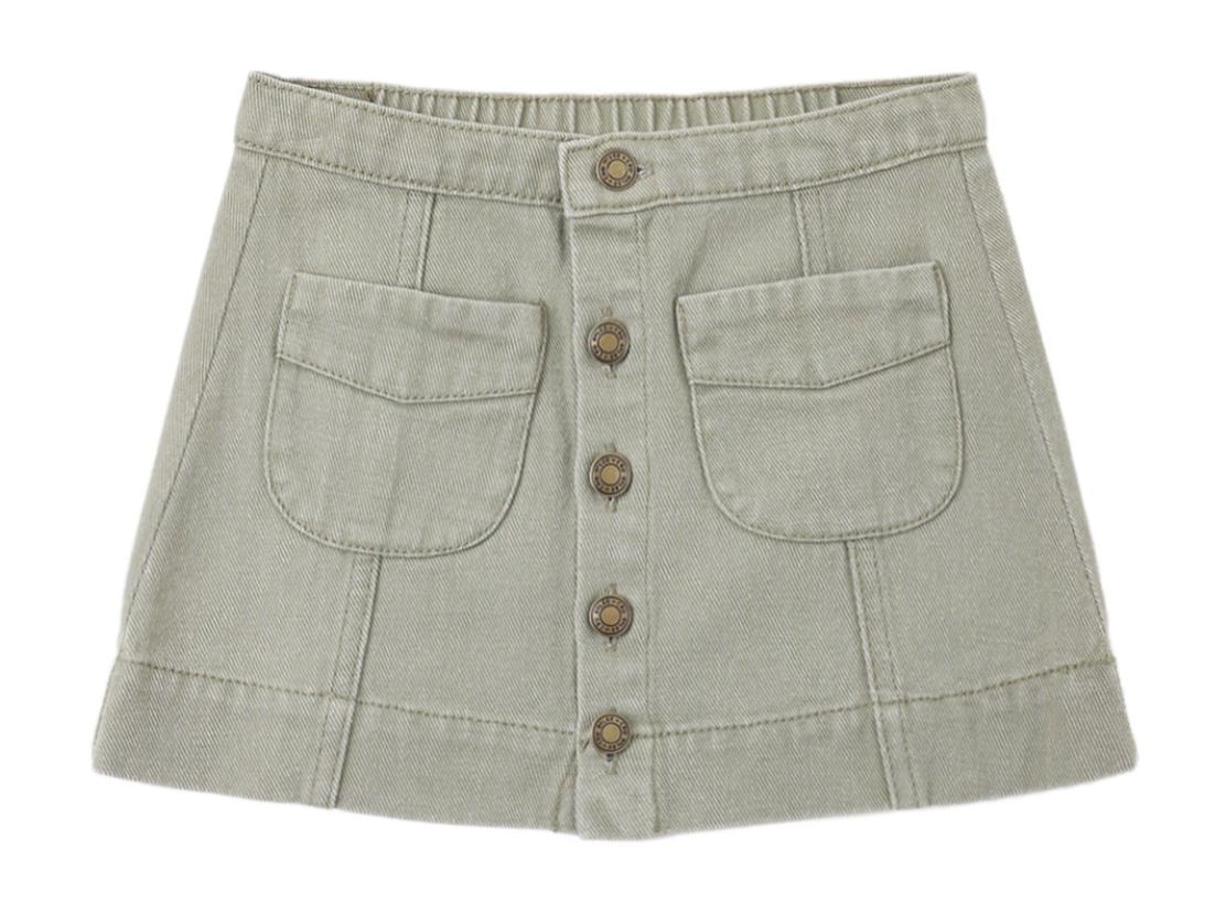 The Girls’ Denver Mini Skirt by Rylee & Cru features a khaki hue, front seam details, five antique brass buttons down the center, two large front pockets, and delicate embroidered stitching for a timeless touch.
