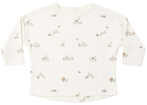 The Quincy Mae Baby and Kids’ Long Sleeve Tee is crafted from organic brushed cotton in classic white and showcases a delightful pattern of small mushrooms, flowers, and rabbits in soft beige and brown hues. Designed with practical shoulder snaps, this comfortable long-sleeve shirt makes dressing easy while keeping your little one cozy all day.