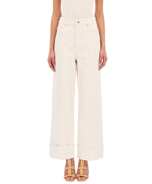 Genevieve Jean showcases effortless style in Ulla Johnson's Genevieve Stretch Jean, a wide-leg white denim pant.