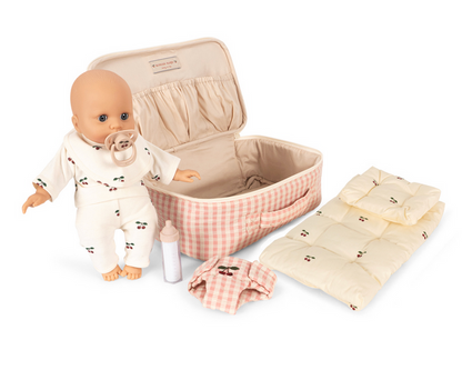 The Konges Slojd Baby Doll Nursery Suitcase includes a soft doll, pacifier, bottle, pink checkered suitcase, and nursery accessories for imaginative play.