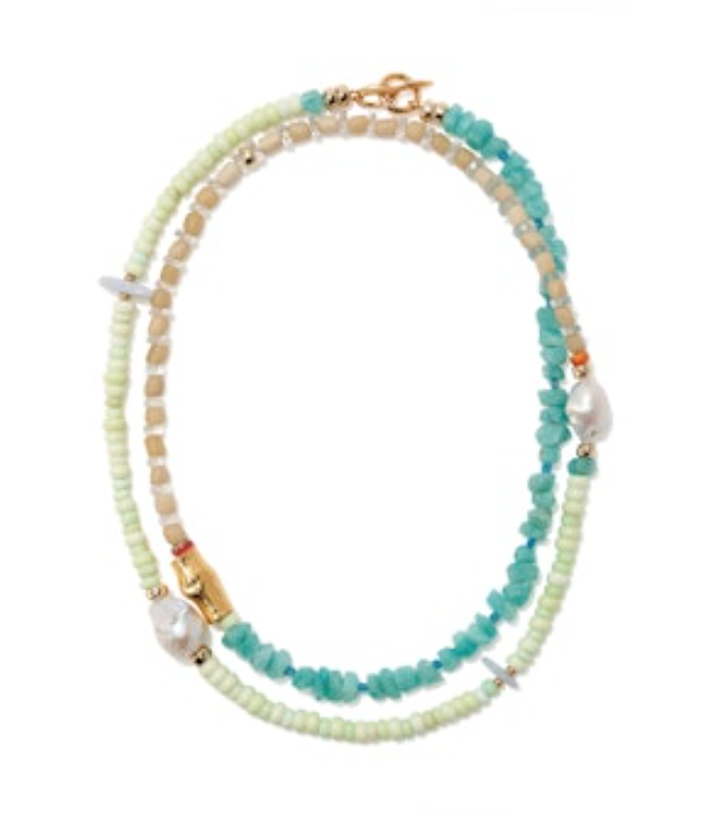 The Lizzie Fortunato Cabana Necklace features semiprecious beads in green, beige, and turquoise, with two pearl accents and a gold clasp.