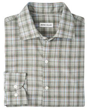 A folded long-sleeve button-up with a green, white, blue, and brown plaid pattern. The Peter Millar Whitecap Performance Flannel Sport Shirt is crafted from lightweight fibers—perfect for fall.