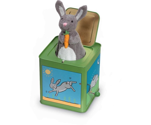 A green Jack-in-the-Box by Jack Rabbit Creations, featuring original artwork on its sides and whimsical rabbit illustrations, with a plush gray rabbit holding a carrot that pops out of the box.