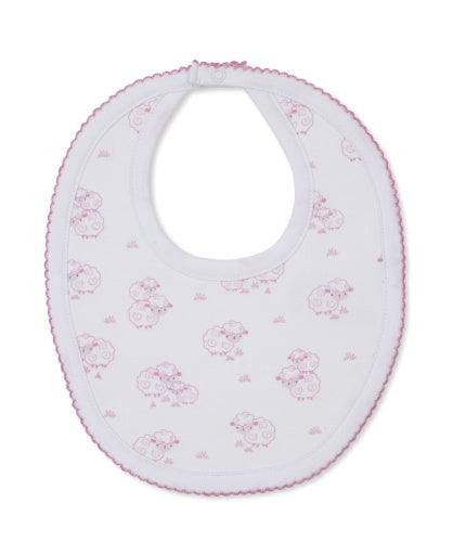 The Kissy Kissy Sweet Sheep Bib, crafted from the softest Pima cotton for exceptional comfort, features a charming pink sheep pattern and pink trim on a white background, and is shown laid flat against a white surface.