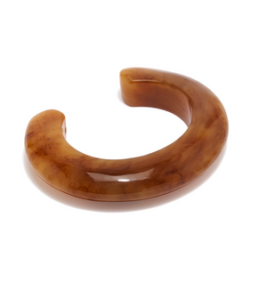 The Ridge Cuff by Lizzie Fortunato is a chunky, curved brown resin bracelet with a marbled pattern, shown on a white background—ideal for stacking with your favorite thin domed cuffs or other resin bracelets.