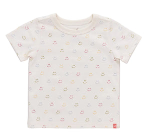 The Kids’ Adventure T-Shirt from Coop Kids PC is a short-sleeved, cream-colored tee adorned with a playful pattern of small, multicolored smiley faces evenly spaced across the fabric and finished with a subtle Coop logo detail.