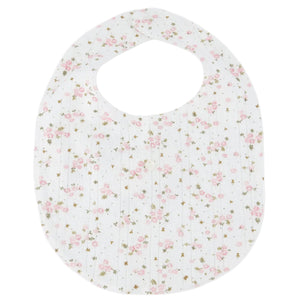 A charming Tartine et Chocolat bib for newborns, featuring a pink floral pattern and a round neck opening, crafted from soft, unbleached cotton and shown laid flat on a plain background—an ideal baby mealtime accessory.
