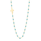 The Gigi Clozeau Side Cross Necklace 16.5" features a timeless design with a sideways cross pendant, turquoise beads, and accents of resin pearls elegantly arranged along an 18 carat gold chain.