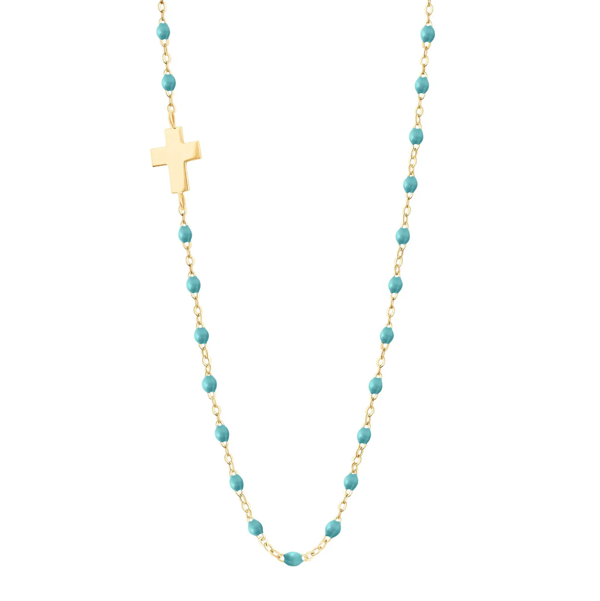 The Gigi Clozeau Side Cross Necklace 16.5" features a timeless design with a sideways cross pendant, turquoise beads, and accents of resin pearls elegantly arranged along an 18 carat gold chain.