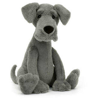 A gray, plush stuffed dog with floppy ears, a large nose, and long, dangly limbs sits upright. This lovable Great Dane stuffed animal perfectly captures the gentle giant essence of the Jellycat Zeus Great Dane.