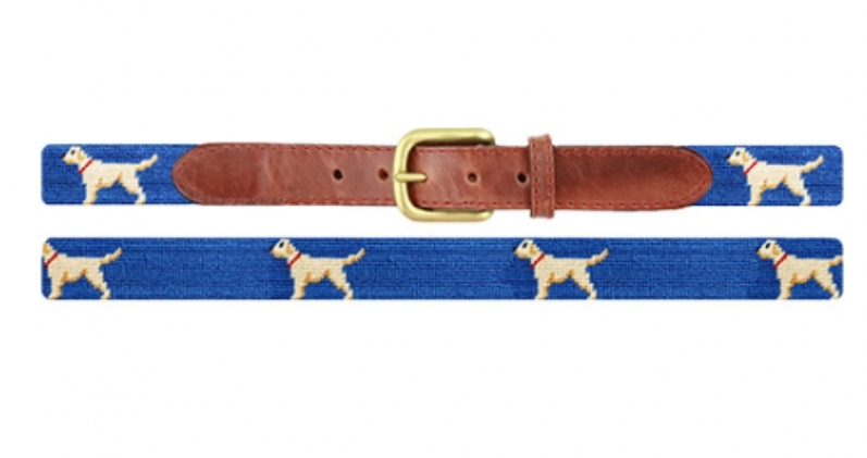 The Smathers & Branson Children's Yellow Lab Belt is a delightful needlepoint accessory for kids, featuring a blue strap paired with a brown full-grain leather buckle area. It is adorned with an adorable pattern of small, standing yellow Labradors, making it perfect for boys' belt sizes and adding a playful touch to any outfit.