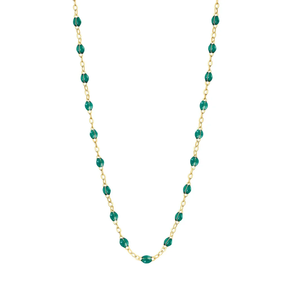 The Gigi Clozeau Classic Gigi Necklace 19.7" features an 18-carat yellow gold chain embellished with delicate small teal beads, offering a perfect touch of elegance.