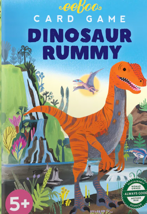Box cover of the Eeboo Dinosaur Rummy Playing Cards, featuring colorful illustrations of dinosaurs and prehistoric plants. This family-friendly game is designed for ages 5 and up and includes a vibrant card deck perfect for young dinosaur enthusiasts.