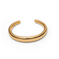 The Amanda Bracelet by Lie Studio is a simple, polished gold bracelet with a smooth, rounded design and open back, shown on a white background.