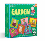 A green box labeled "Eeboo Garden Little Square Memory Game" by Eeboo, suitable for ages 3+. Features illustrations of animals and plants. The box indicates it contains 18 pairs to match and is made with recycled board, emphasizing the brand's commitment to sustainability.