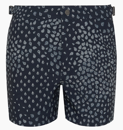 The Onia Calder Buckle 5" Swim Trunk for men in navy blue features quick-drying fabric, an adjustable waistband, and a white geometric drop pattern.