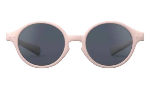 The IZIPIZI Baby #D Polarized Sunglasses feature a lightweight, round design with a light pink frame and dark lenses for UV protection, displayed on a white background.