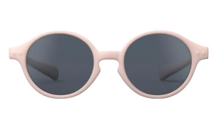 The IZIPIZI Baby #D Polarized Sunglasses feature a lightweight, round design with a light pink frame and dark lenses for UV protection, displayed on a white background.