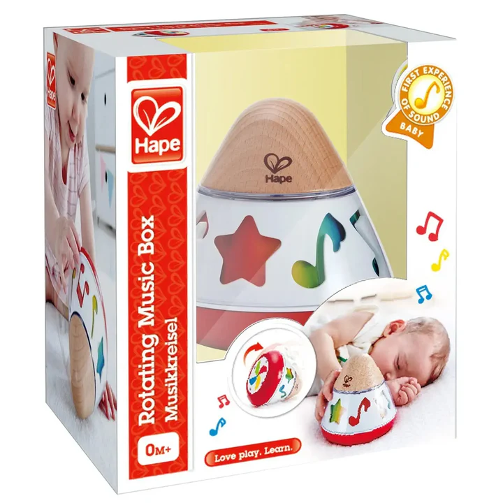 Hape Rotating Music Box in packaging, with a wooden top, colorful star cutouts, musical notes, and images of a baby playing and sleeping next to the soothing Hape toy.