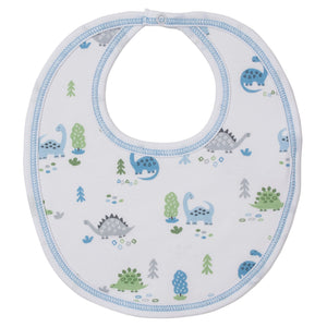 The Kissy Kissy Dinosaur Era Bib is a soft white Pima cotton baby boy bib with blue trim, decorated with cute blue and green cartoon dinosaurs and small trees.
