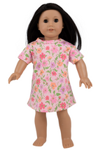 A brown-haired doll wearing Dolly's Polly Play Dress by The Beaufort Bonnet Company stands upright against a plain white background.