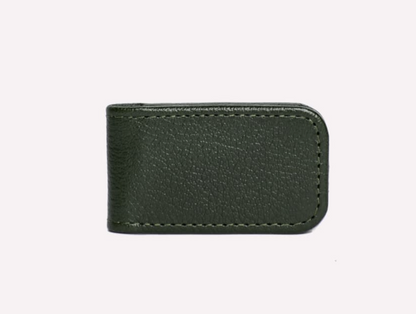 The Ettinger Capra Magnetic Cash Clip is a minimalist money clip in dark green luxury goat leather with visible stitching, shown against a plain light background.
