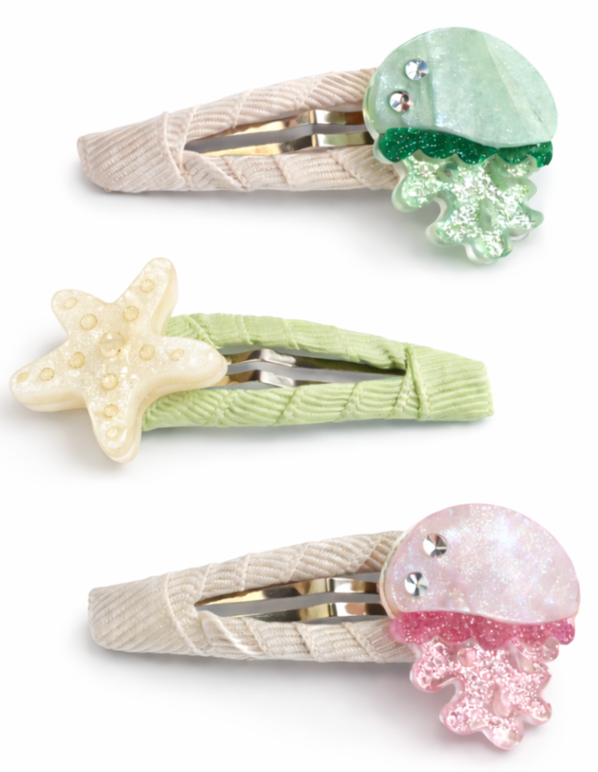 Add a playful, beachy vibe to your look with the Lillies & Roses Jellyfish Green Pink Snap Clips. This set includes three handmade hair accessories: a green jellyfish, a pink jellyfish, and a cream starfish, each attached to fabric-covered clips in beige or green. Perfect for sunny outings or days by the ocean!.
