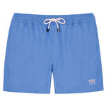 The Mens Plain Trunks by Pink House Mustique are blue swim trunks with an elastic waistband, white drawstring, and a small palm tree embroidery on the lower left leg. They feature a Velcro back pocket and are shown against a white background.