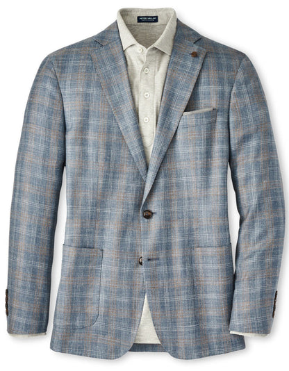 A Peter Millar Andover Plaid Soft Jacket in blue with Italian horn buttons, featuring a chest pocket and two front pockets, displayed over a light grey button-down shirt.