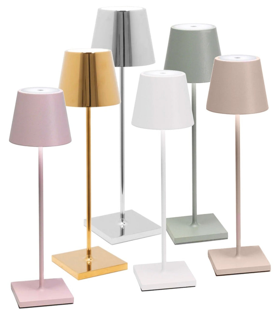 The Test 3 collection by Hive Boutiques includes a set of six table lamps for kids, showcasing vibrant colors and metallic finishes. Each lamp features a conical shade and a square base.