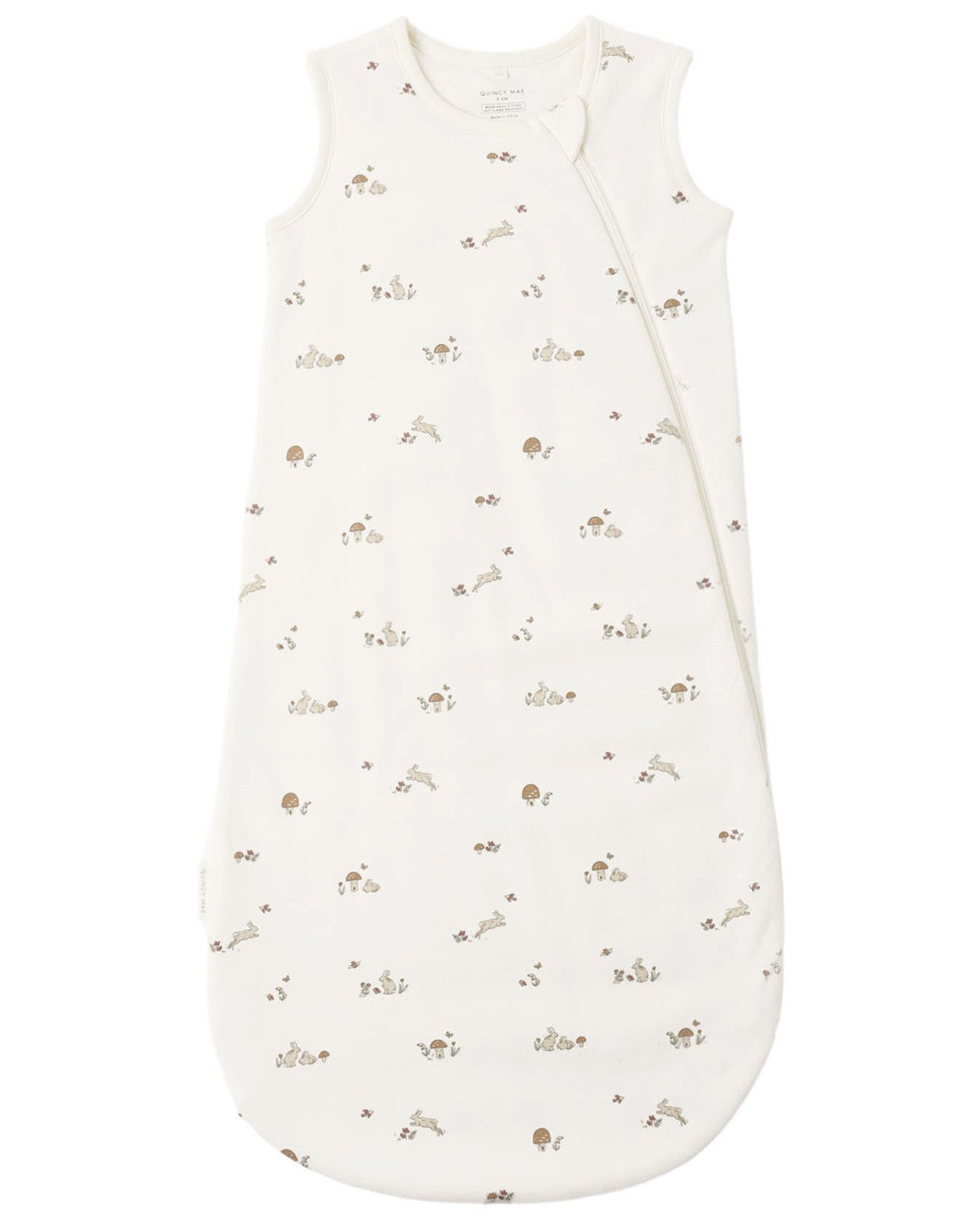 The Quincy Mae Baby Jersey Sleep Bag is made from organic brushed cotton and features a sleeveless white design with a convenient double zip side opening. It is decorated with a charming small animal and leaf print in neutral beige and brown tones.