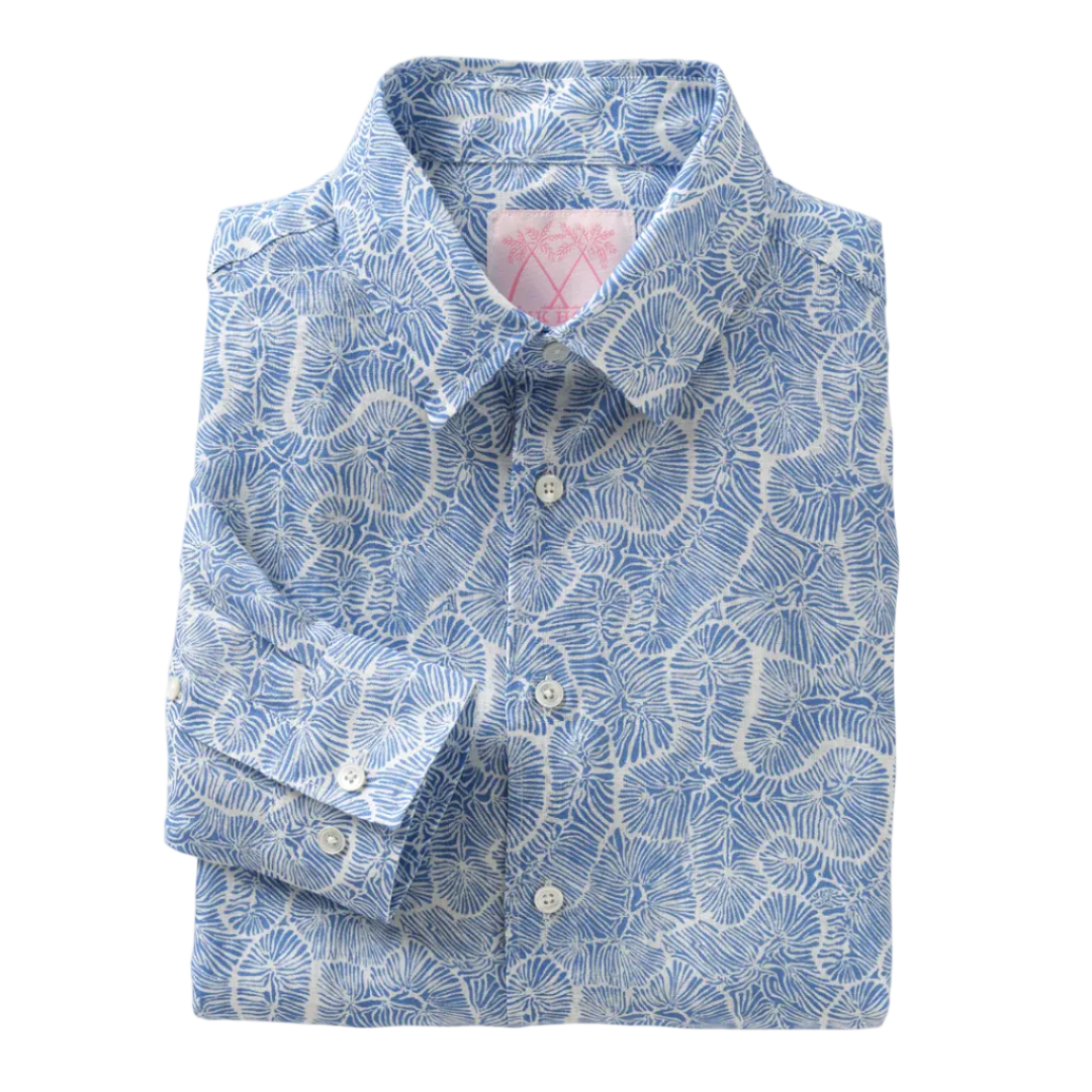 The Pink House Mustique Printed Linen Shirt, featuring a blue and white abstract leaf design and inspired by the relaxed elegance of Mustique, is shown neatly folded with long sleeves and button-up front on a plain white background.