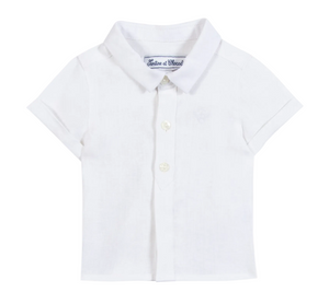 The Tartine et Chocolat Baby Boys’ and Boys’ Linen Collared Shirt, shown front-facing on a plain background, is a short-sleeve white linen shirt that offers timeless elegance for special occasions or everyday wear.