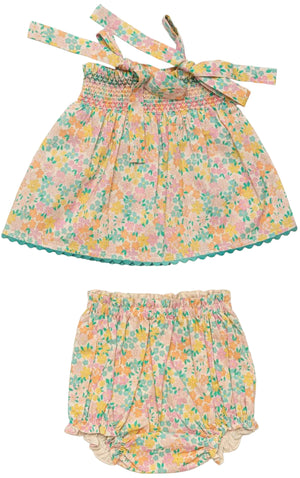 The Early Sunday Baby Girls’ Didi Baby Smock Top & Bloomer Set is a two-piece outfit made from soft organic cotton, featuring a sleeveless top with charming shoulder ties and a scalloped hem, paired with matching bloomers. Both pieces display a playful pink, green, yellow, and orange print for an adorable look.