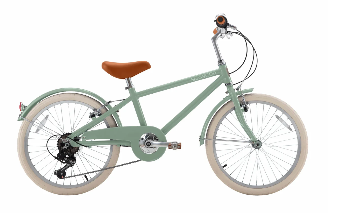 The Banwood Kids’ Vintage Classic Bike features a light green frame, seven-speed gearing, tan seat and handlebars, white tires, rear gear set, and both front and rear fenders, displayed on a white background.