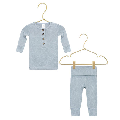 Lou Lou & Company Baby Boys’ and Boys’ Miller Plush Knit Top & Bottoms set in light blue, featuring a silky-soft fabric with long sleeves, buttons on the top, and matching pants—shown on two gold hangers against a white background.