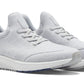 The Peter Millar Tellustride Sneaker is a pair of light gray knit sneakers with white soles, featuring laces and a cushioned design, enhanced by a memory foam insole for ultimate comfort.