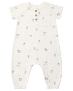The Quincy Mae Baby Short Sleeve Jumpsuit features a white design adorned with small gray sheep patterns, a chest pocket, three coconut buttons down the front for easy changes, and elastic cuffs at the ankles.