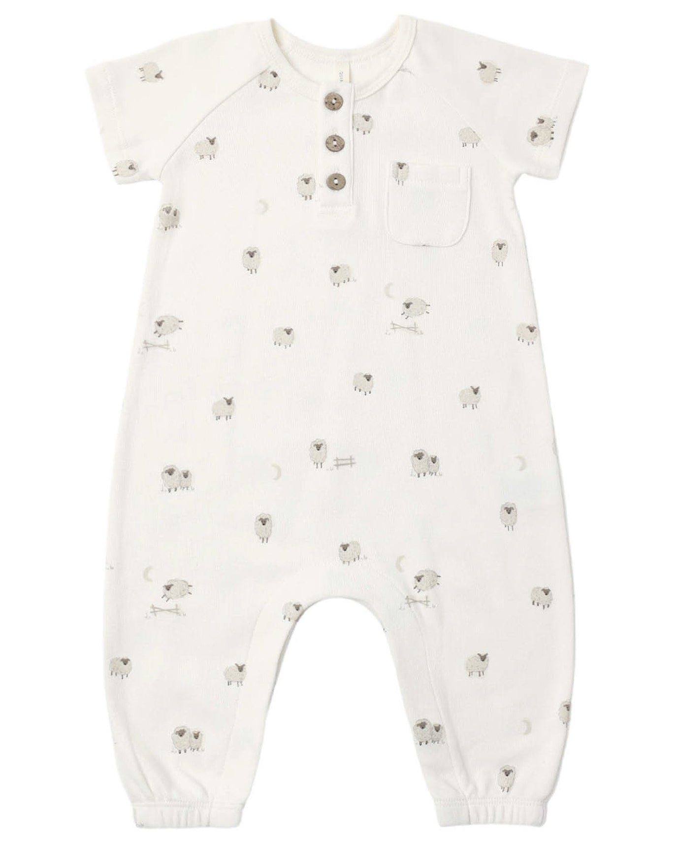 The Quincy Mae Baby Short Sleeve Jumpsuit features a white design adorned with small gray sheep patterns, a chest pocket, three coconut buttons down the front for easy changes, and elastic cuffs at the ankles.