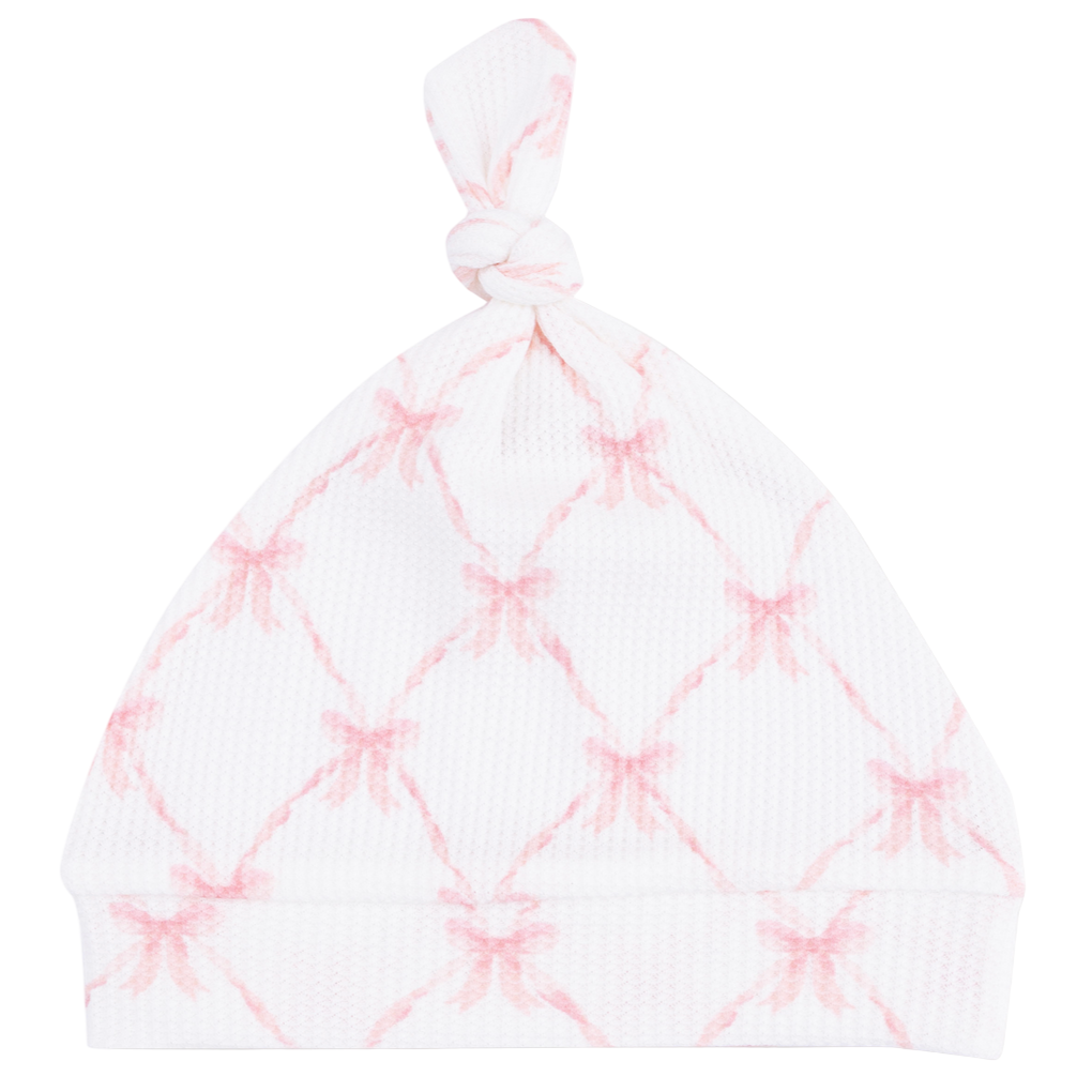 The Angel Dear Knotted Hat features a light pink crisscross pattern with pink bows at each intersection, crafted from soft bamboo for babies.